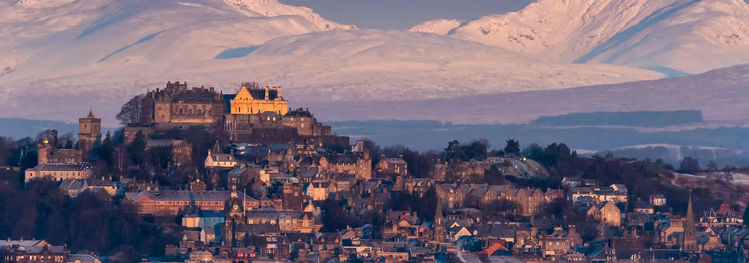 a view of stirling castle and the town centre in winter